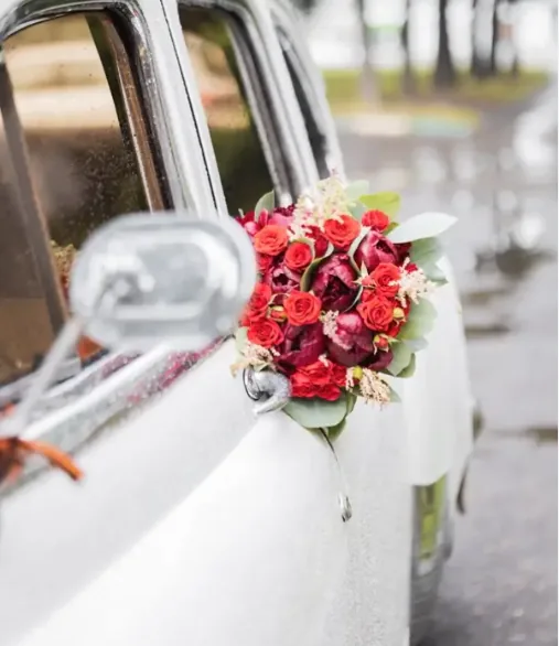 White wedding car decorated with flowers for bridal party transfers